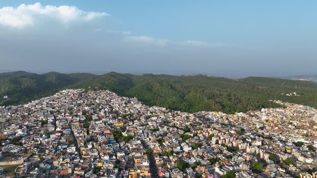 Aerial Pull-Back Shot Tilting Down on Overpopulated City Infrastructure