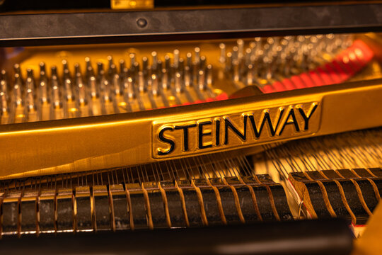Close up of golden cast iron plate with Steinway inscription inside grand piano