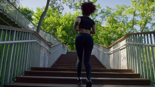 Woman running up outdoor park stairs