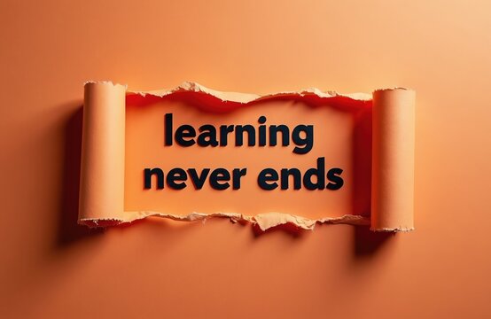 Text phrase learning never ends on torn paper background. Concept of continuous education and self-improvement. Ideas for personal growth and skill development.