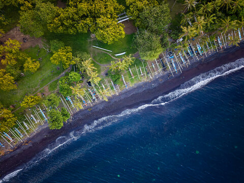 High angle view of black sand coast with palm trees in Tulamben, Bali