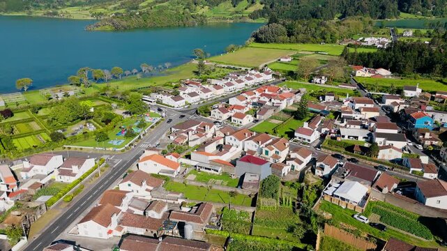 Drone view of Sete Cidades village near turquoise lake in Azores