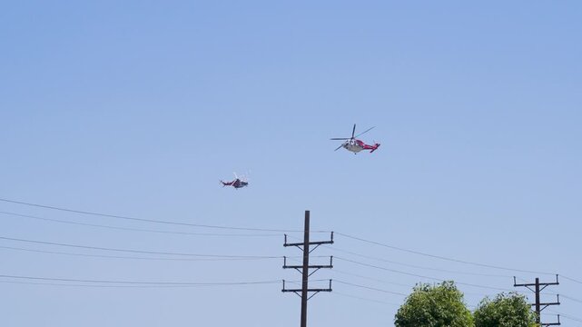 Slow motion shot of Los Angeles Fire Department responding to wildfire with aerial unit dropping water 