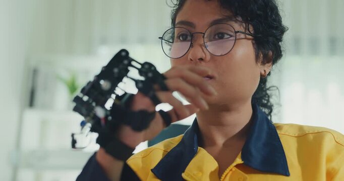 Young Black female engineer coding AI robot arm in modern laboratory. Robotics, artificial intelligence, technology, stem, future, innovation, diversity, automation, machine learning concept.