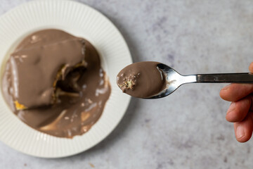Fototapeta premium Eating Chocolate Covered Sponge Cake