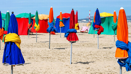 Colorful Beach Umbrellas on Normandy Coast with Copy Space © Svitlana