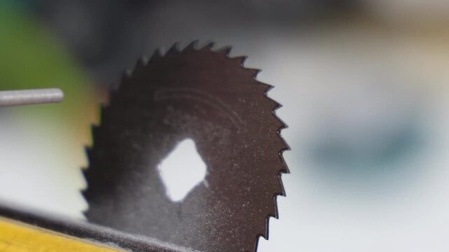 Macro shot of a precision rotary tool bit adjusting a miniature circular saw blade