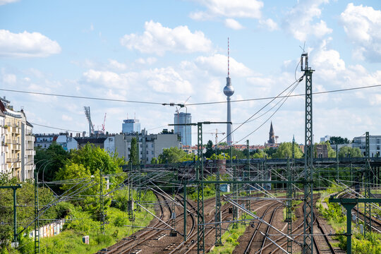 Railway tracks leading towards Berlin skyline with TV Tower in Germany 10