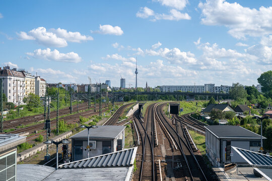 Railway tracks leading towards Berlin skyline with TV Tower in Germany 12