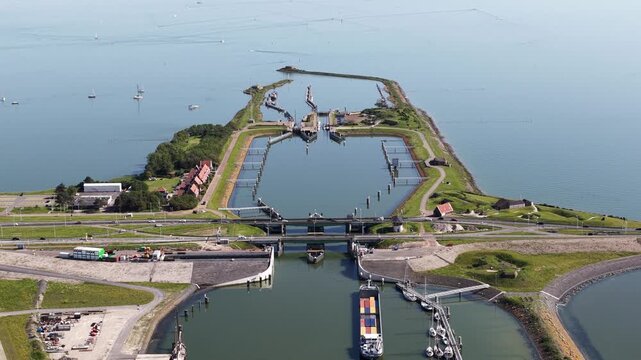Aerial view of cargo ship passing through lorentz locks at afsluitdijk