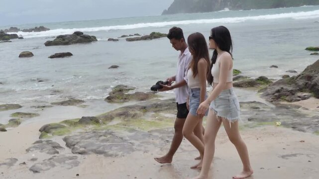 Young Friends Walking Along Wedi Ombo Beach in Yogyakarta Indonesia