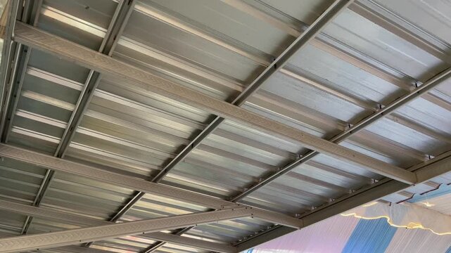 Interior view of galvalume corrugated steel roofing on metal truss system