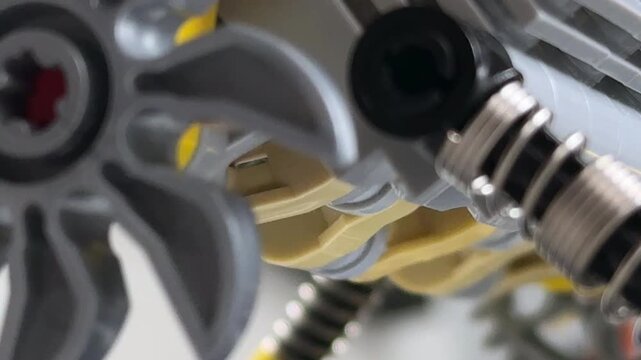 Macro selective focus on plastic pistons and suspension springs of a toy car engine block