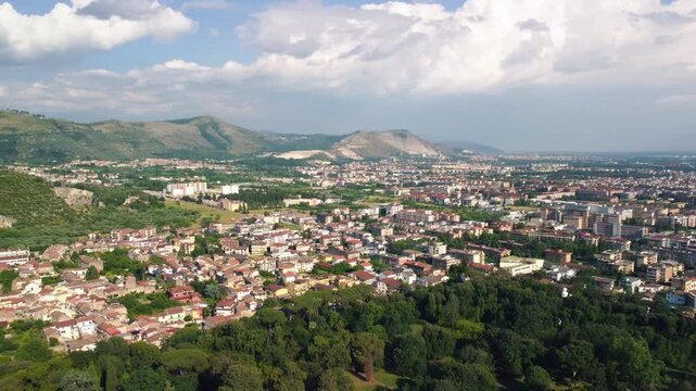 Panoramic drone shot of Caserta Royal Palace and formal gardens under summer sunlight