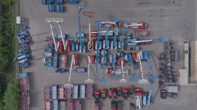 Top down drone pull up over aerial work platforms and construction equipment
