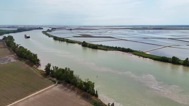 Cargo ship navigating Guadalquivir river in Andalusia