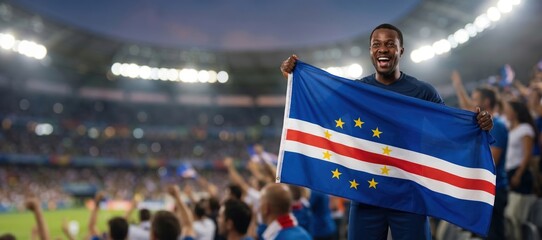 Obraz premium Cape Verde football fan celebrating with national flag in stadium