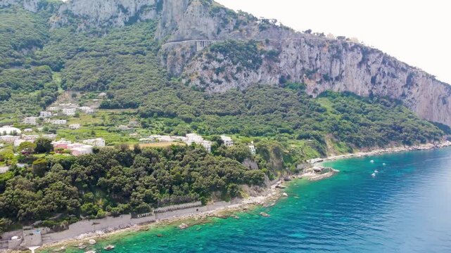 Stunning drone perspective over Marina Grande harbor and Capri island coastline