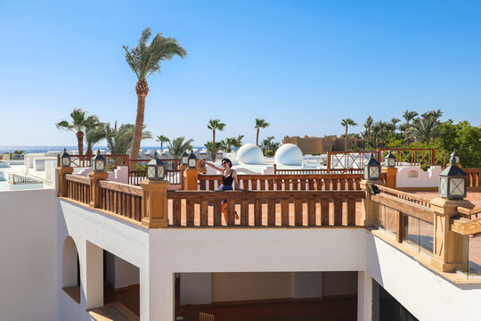 Traveler Woman Enjoying Breathtaking Sea View from Spacious Balcony of Egyptian Hotel, Embracing the Serenity Nature and Adventure.