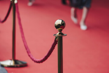 Naklejka premium Red carpet on a movie premiere, cinema film festival event, ropes and golden barriers on a luxury party entrance, awards gala ceremony, wealthy rich guests arriving, outdoor venue decoration elements