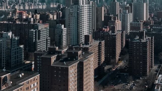 Aerial view of upper east side manhattan skyline showing dense residential buildings and central park reservoir in new york city.