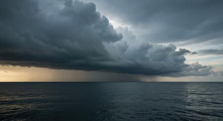 Obraz premium Dramatic storm clouds over ocean, with rain, and moody atmosphere