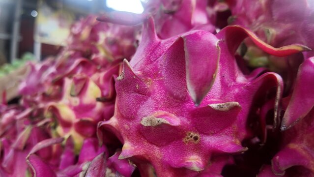 Photo of red dragon fruit skin, which looks like scales