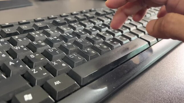 Close-up of Hand Typing on a Bilingual English and Bengali Computer Keyboard, Male Finger Pressing Keys on Black Desktop PC Keyboard for Office Work - 4K B-Roll