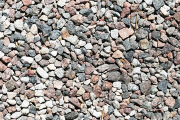 Naklejka premium Granite gravel texture background. Small colorful stones covering ground surface. Natural rock pattern useful for construction themes landscaping projects and abstract texture design.