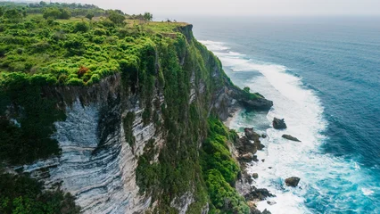 Dramatic ocean cliffs with crashing waves on a coastline © artifirsov