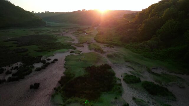Sunrise at Three Cliffs Bay in Wales. Drone flight