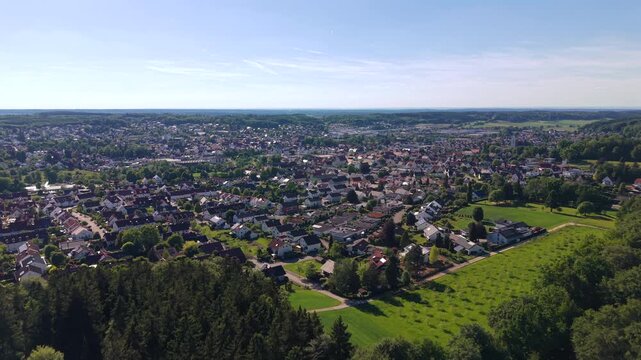 Aerial view of Krumbach in Swabia, Bavaria. Drone footage of the historic townscape, traditional houses and green trees on a sunny summer day in Germany.