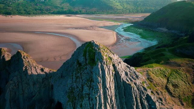 Sunrise at Three Cliffs Bay in Wales. Drone flight