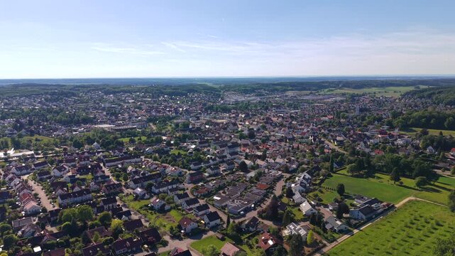 Panoramic drone shot of Krumbach, Germany. Beautiful aerial panorama of the entire town, residential areas and scenic countryside in Bavaria during summer.