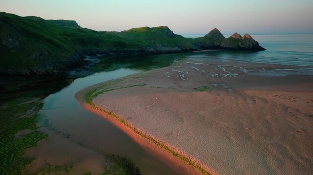 Sunrise at Three Cliffs Bay in Wales. Drone flight