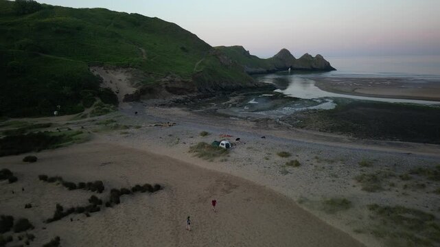 Sunrise at Three Cliffs Bay in Wales. Drone flight