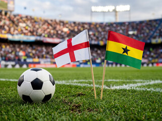 Naklejka premium England and Ghana flags with football on green field