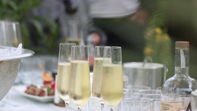 Selective focus on sparkling wine in flute glasses during a restaurant banquet celebration