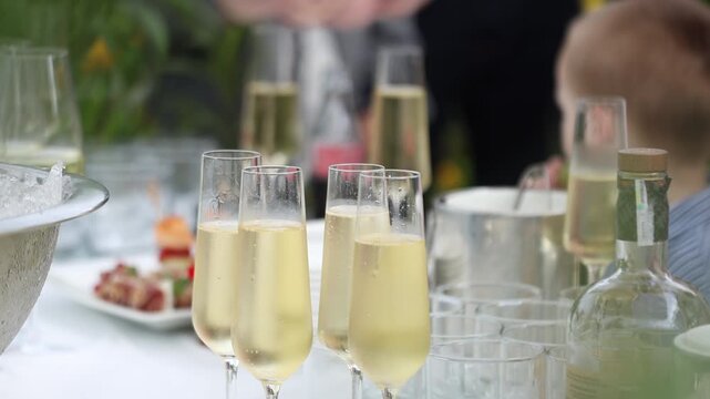 Glasses of chilled champagne served for guests at a festive outdoor dinner party