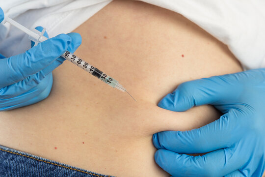 ghk cu peptide injection subcutaneous belly fold syringe hands analog ingredients therapy close up view looking away concept of cosmetology, biochemistry, pharmacology
