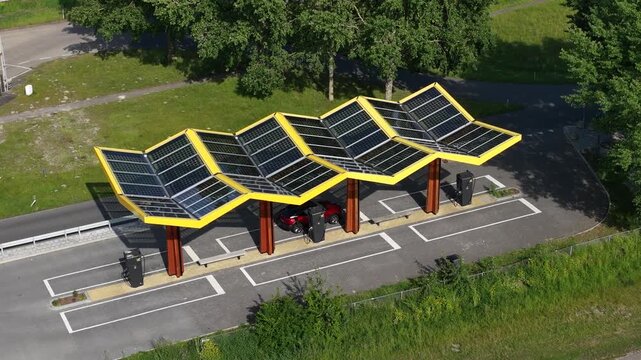 Aerial view of electric car charging at a solar powered station