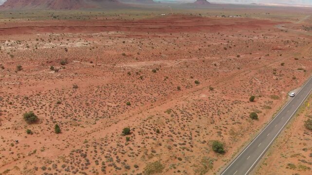 Monument Valley Mountains and road, aerial view from drone. Slow motion