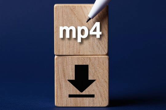 Wooden blocks show mp4 text and download icon. Concept for downloading video files online. Digital content transfer. Save media data. Get film or clip. Save MP4 format.