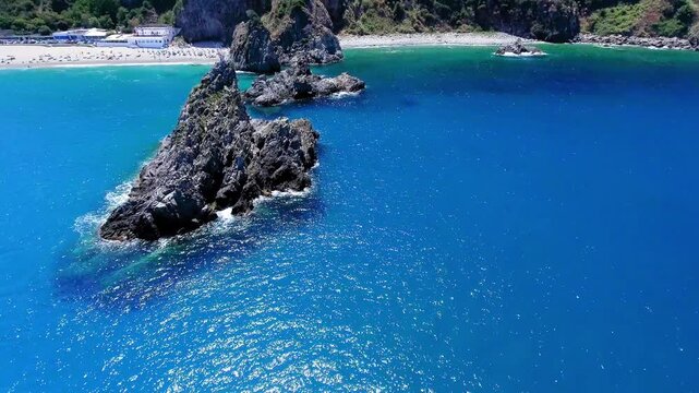 Ulivarella Beach and Ulivo Rock aerial view in slow motion, Calabria, Italy