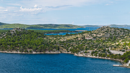 Fototapeta premium Scenic aerial view of the Adriatic Sea coastline with green islands and blue water in Croatia