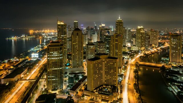 modern city lights of manila philippines night skyline aerial timelapse