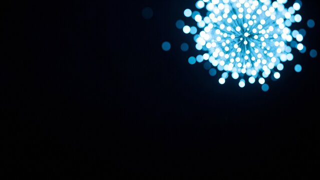 Commercial visualization of bright blue particle cluster radiating energy in darkness