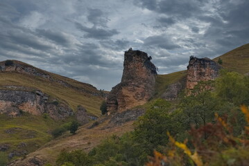 Obraz premium Russia, the North Caucasus, Kabardino-Balkaria. View of a group of undisturbed remains surrounded by gentle slopes of crumbling mountains.