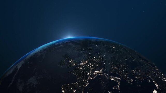 Cinematic view of planet Earth from orbit with glowing atmosphere, city lights and sunrise over the horizon. Realistic space scene featuring the curvature of the planet, clouds, stars and illuminated 