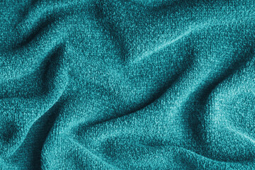 Closeup, macro of turquoise microfiber fabric texture with soft folds and drapery. Plush, fleece textile surface suitable for background, wallpaper and design use. Upholstery, decorative cloth © katyamaximenko